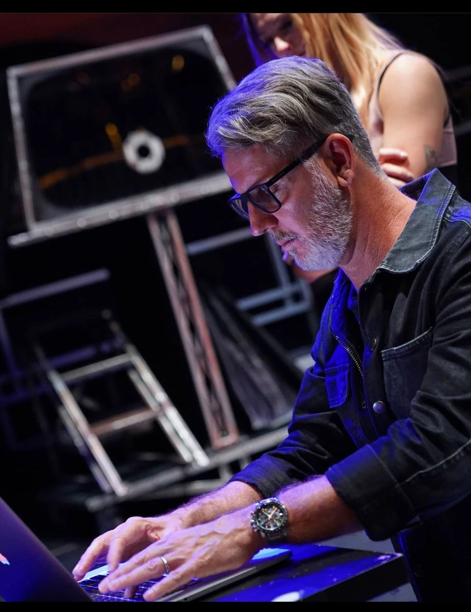 John Taylor developing an original stage illusion at his computer beside the apparatus