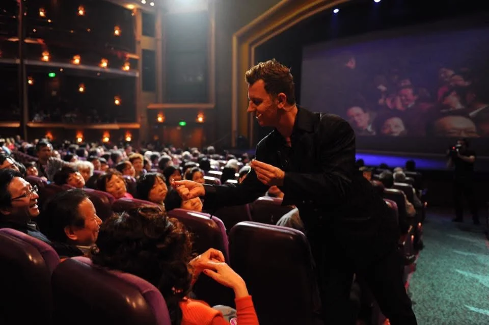 John Taylor performing close to the audience during a live magic show