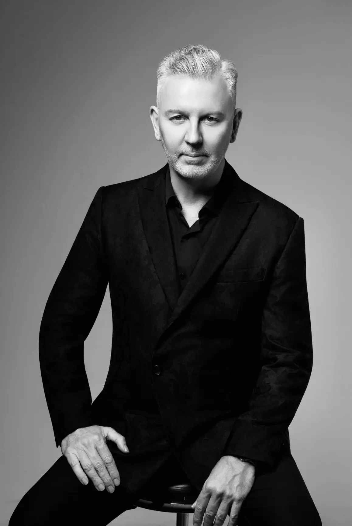Black and white studio portrait of John Taylor