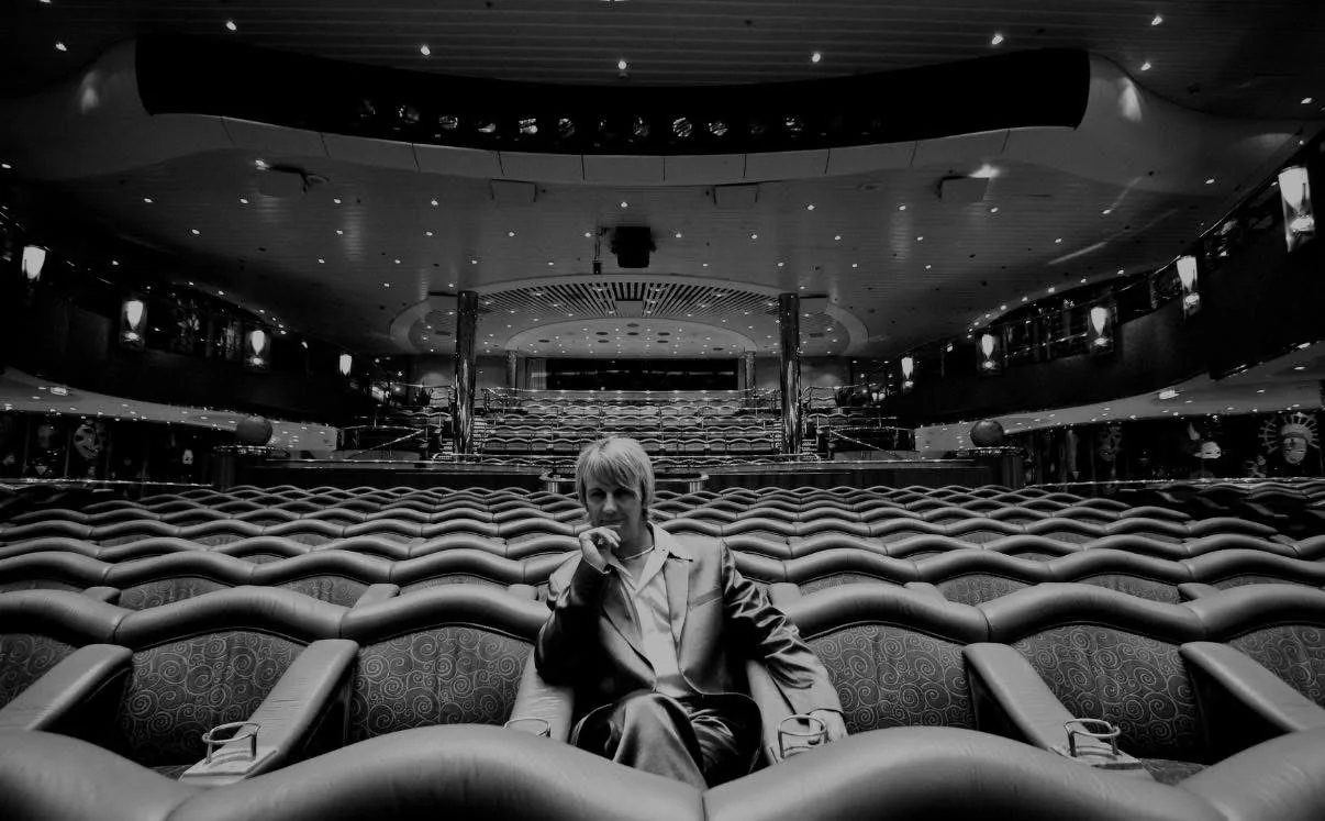 John Taylor sitting in a theatre